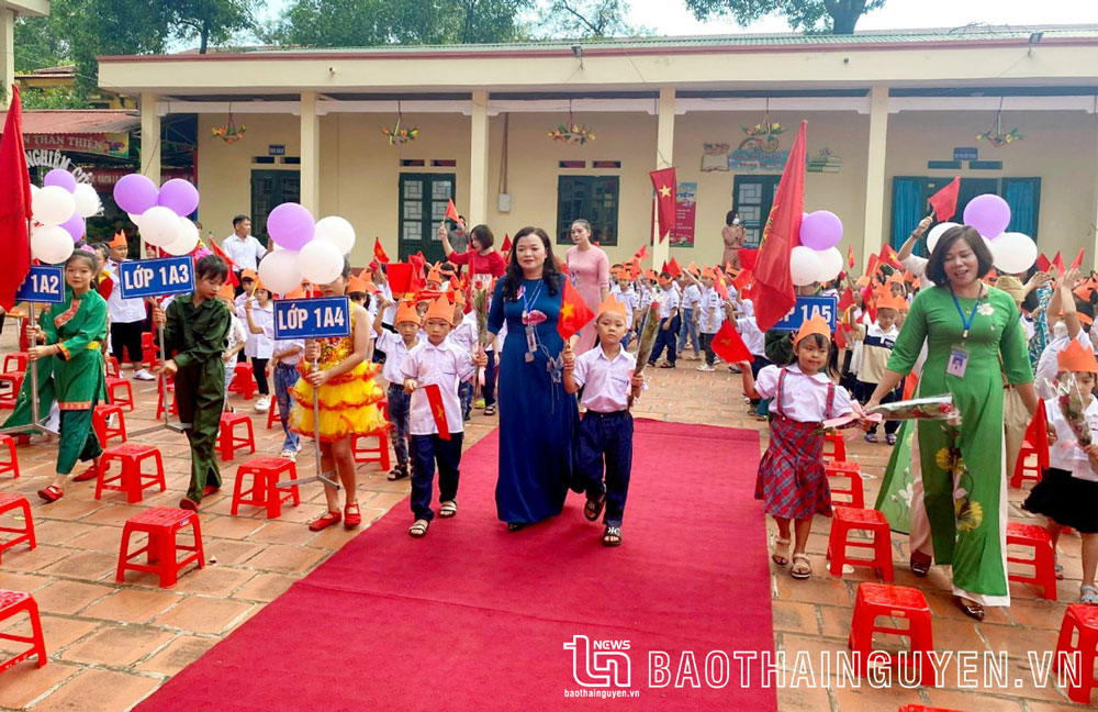 Nhà giáo Ưu tú Vũ Thị Thanh, Hiệu trưởng Trường Tiểu học Hương Sơn (bên trái ảnh) đón học sinh lớp 1 tại Lễ khai giảng năm học 2022-2023.