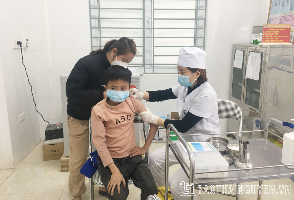 Cán bộ Trạm Y tế xã Thần Sa (Võ Nhai) tiêm vắc-xin phòng COVID-19 cho trẻ.