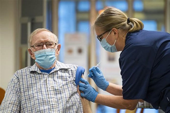 Nhân viên y tế tiêm vaccine phòng Covid-19 của hãng dược Pfizer cho người dân tại Sodermanland, Thụy Điển. (Ảnh: AFP/TTXVN)