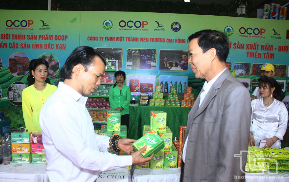 Ông Đỗ Mạnh Hùng, Giám đốc Công ty TNHH Một thành viên Thương mại Hùng Thái (bên trái), giới thiệu sản phẩm trà lắc có thành phần trà xanh với khách hàng.