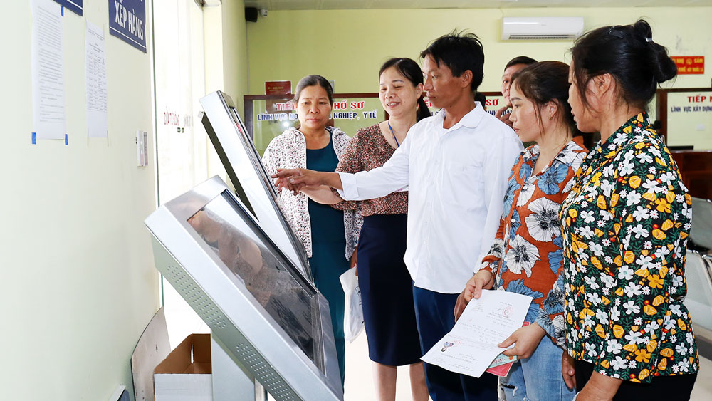 Cán bộ UBND huyện Phú Bình hướng dẫn người dân đến làm thủ tục tại bộ phận một cửa của huyện.